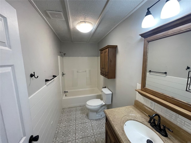bathroom with decorative backsplash, toilet, shower / bathtub combination, vanity, and a textured ceiling