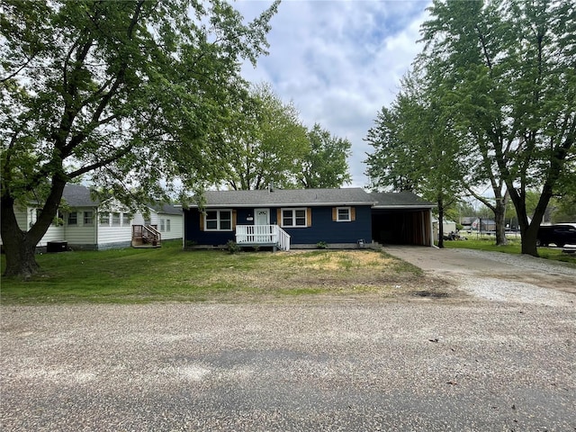 single story home with a front yard, concrete driveway, and an attached carport