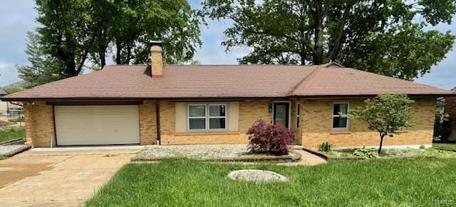 single story home with a chimney, a front yard, a garage, brick siding, and concrete driveway