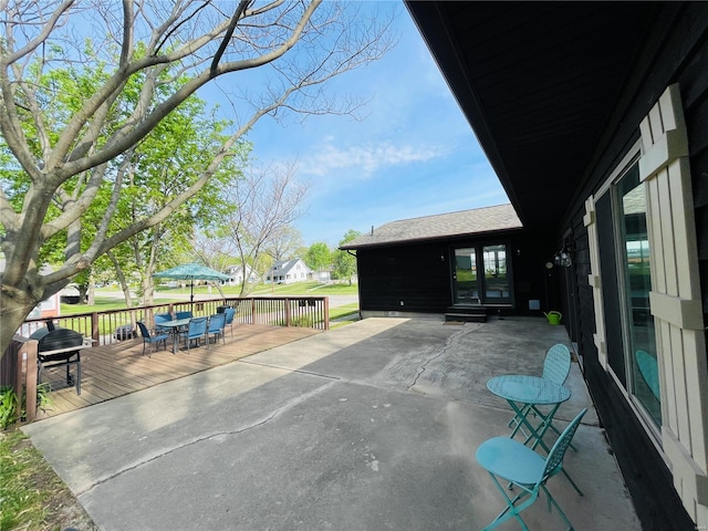 view of patio / terrace with a wooden deck and outdoor dining area