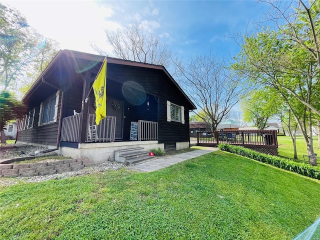 view of front of property with covered porch and a front yard