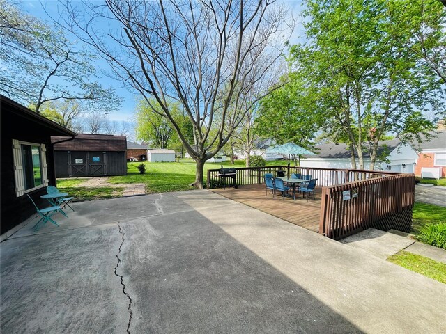 view of patio featuring outdoor dining area and a wooden deck