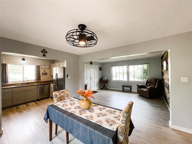 dining area with baseboards and light wood-type flooring