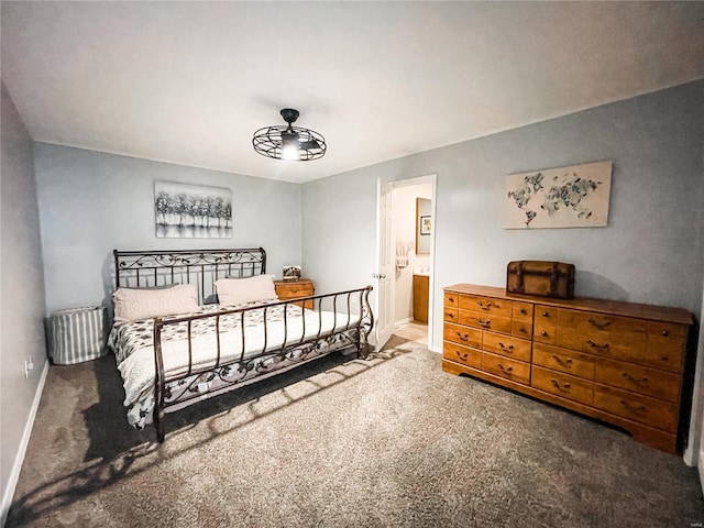 bedroom featuring connected bathroom, carpet floors, and baseboards