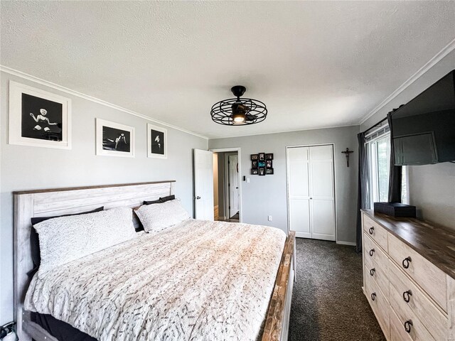 bedroom featuring a closet, dark carpet, a textured ceiling, and ornamental molding