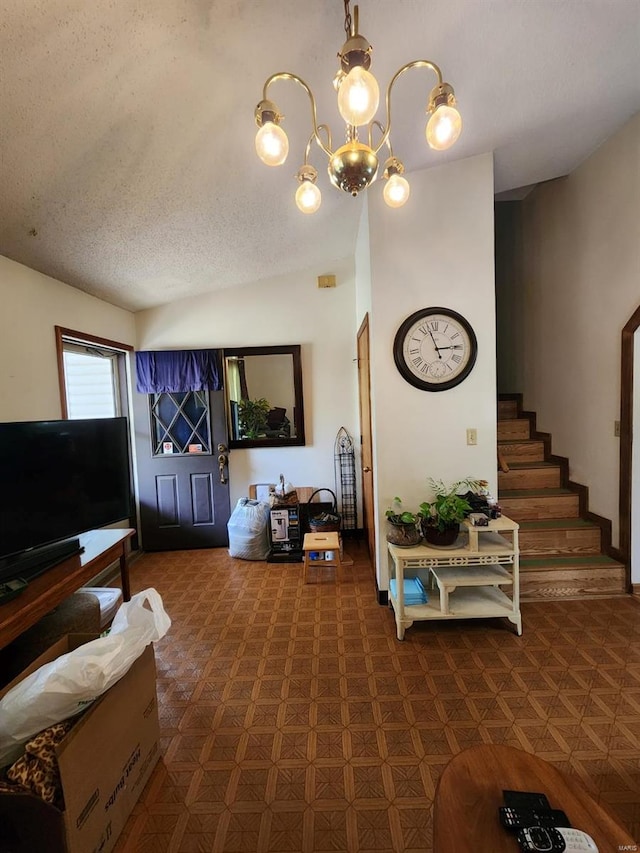living area featuring stairway and an inviting chandelier