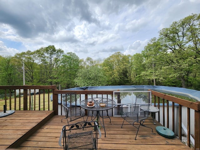 wooden deck featuring a forest view