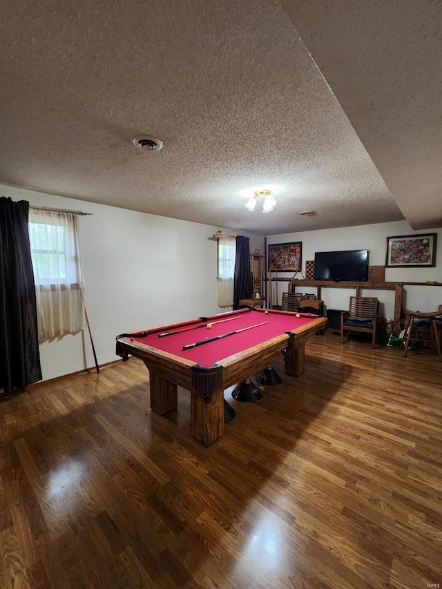 recreation room with wood finished floors, a textured ceiling, and billiards