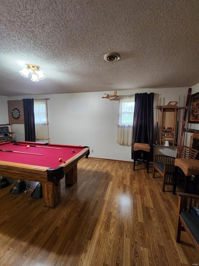recreation room featuring a textured ceiling, billiards, and wood finished floors
