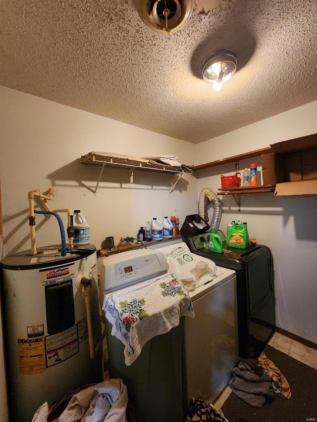 clothes washing area featuring a textured ceiling, water heater, laundry area, and washer and clothes dryer