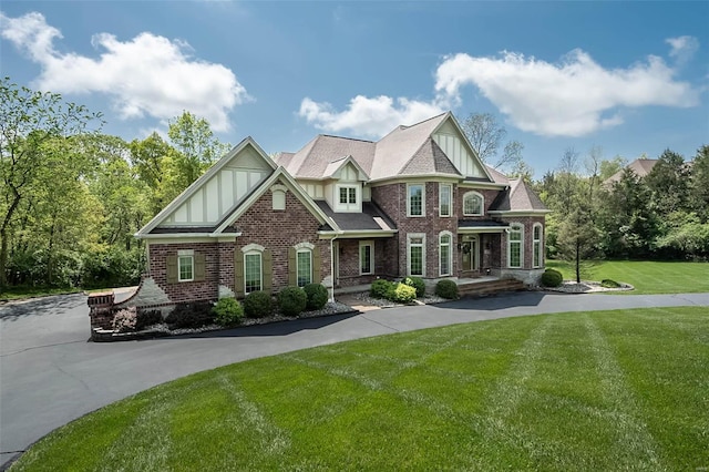 view of front facade featuring brick siding and a front yard