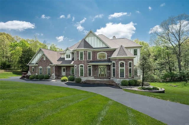 view of front of home with a front yard and brick siding