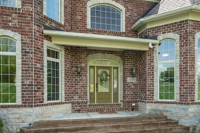 property entrance with brick siding