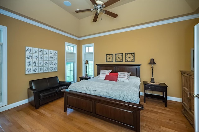 bedroom featuring baseboards, a ceiling fan, and light wood-style flooring