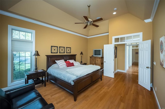 bedroom featuring crown molding, light wood-style floors, ceiling fan, baseboards, and high vaulted ceiling