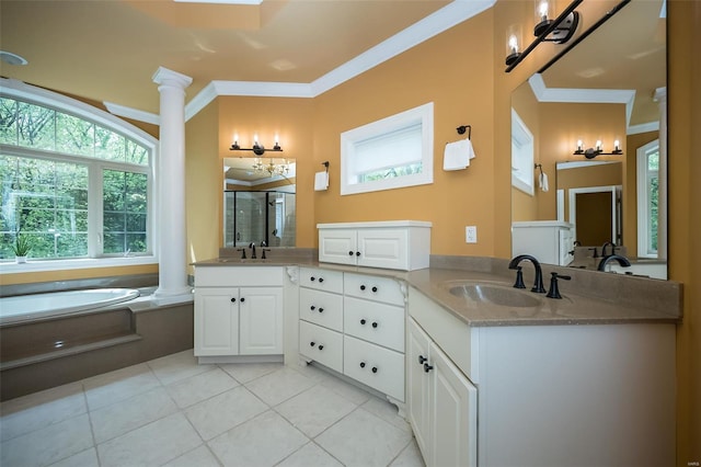 bathroom with tile patterned flooring, decorative columns, a bath, vanity, and a stall shower