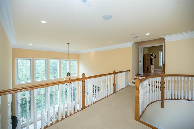 hallway with ornamental molding, recessed lighting, an inviting chandelier, and visible vents