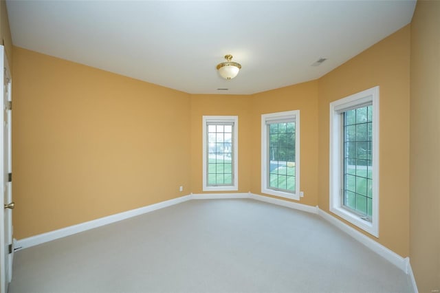 carpeted spare room with baseboards