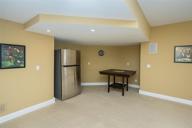 kitchen featuring light colored carpet, visible vents, freestanding refrigerator, baseboards, and recessed lighting