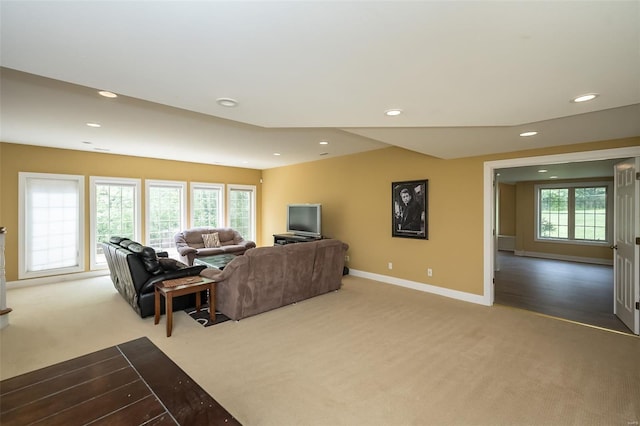 carpeted living room with recessed lighting and baseboards