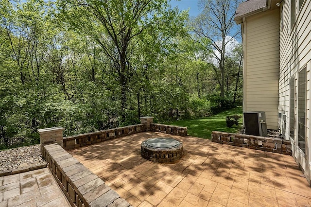 view of patio / terrace featuring an outdoor fire pit and central air condition unit