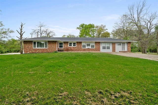 ranch-style home with brick siding and a front lawn