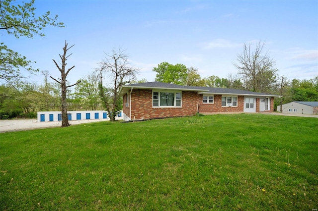 view of front of property with a front lawn and brick siding