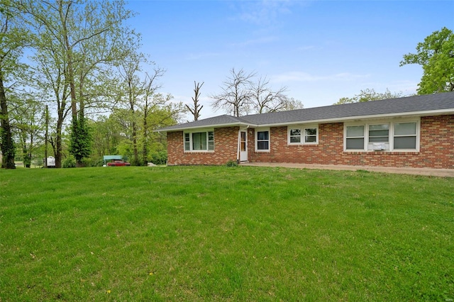 single story home with brick siding and a front yard
