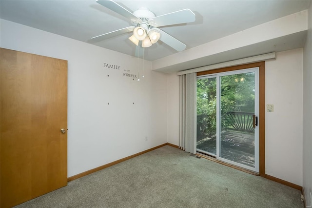 empty room with carpet, visible vents, ceiling fan, and baseboards