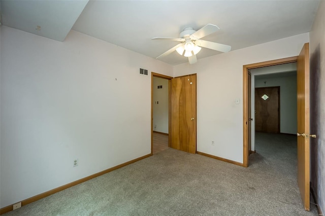 unfurnished bedroom featuring visible vents, ceiling fan, carpet, and baseboards