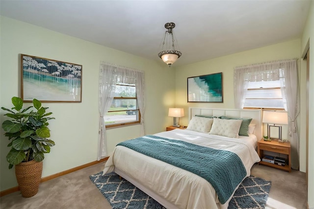 bedroom with baseboards and carpet floors