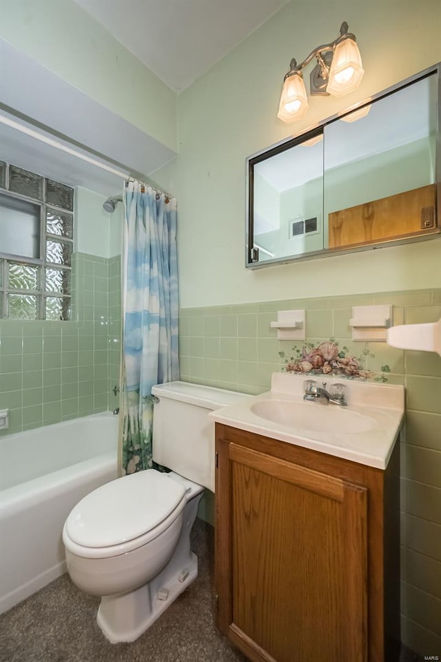 full bath with a wainscoted wall, toilet, shower / bath combination with curtain, tile walls, and vanity