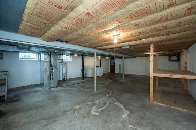 below grade area with heating unit, washing machine and clothes dryer, and water heater