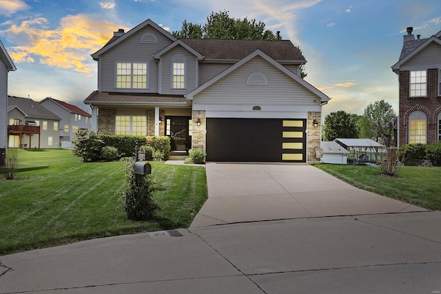 traditional-style home featuring a garage, a front yard, a chimney, brick siding, and driveway