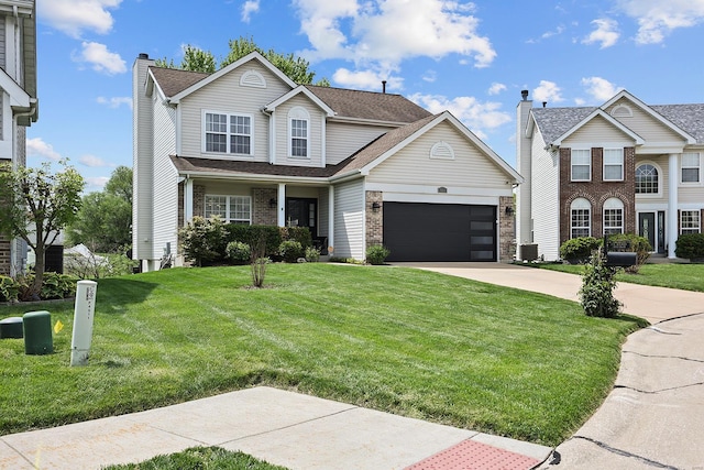 traditional home featuring a front yard, roof with shingles, a chimney, an attached garage, and driveway