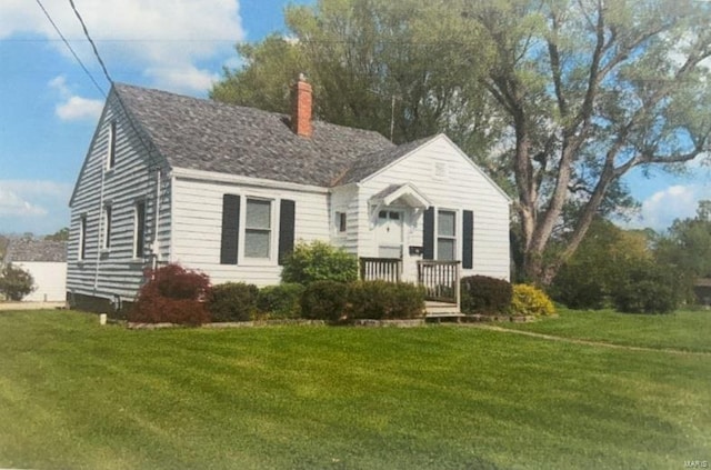 view of front of property with a front lawn and a chimney