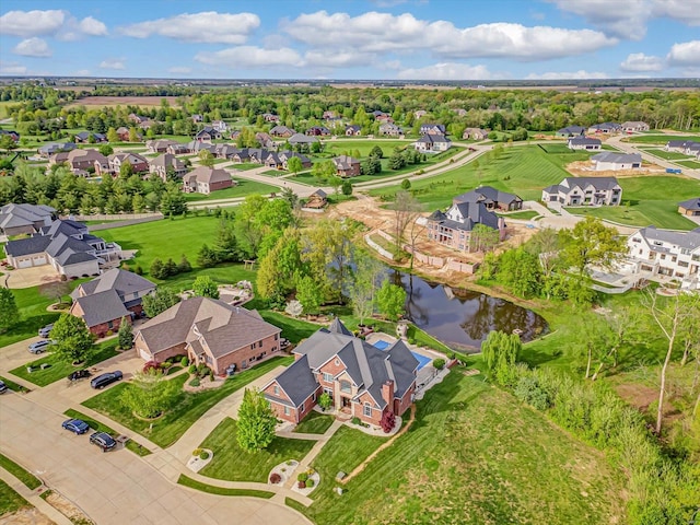 drone / aerial view with a water view and a residential view