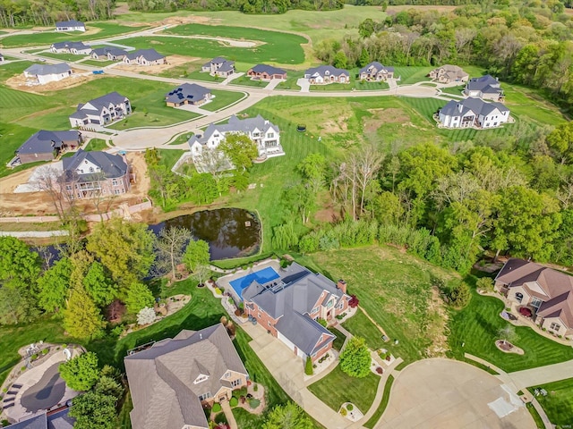 birds eye view of property with a residential view, a water view, and golf course view