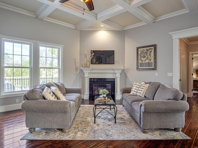 living room featuring beam ceiling, a glass covered fireplace, hardwood / wood-style flooring, and coffered ceiling