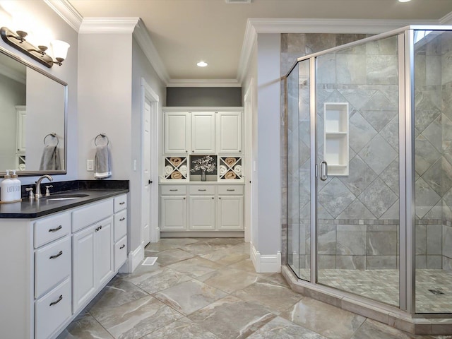 bathroom with vanity, a stall shower, marble finish floor, baseboards, and ornamental molding