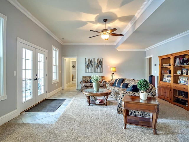 living area with carpet floors, tile patterned floors, crown molding, a ceiling fan, and french doors