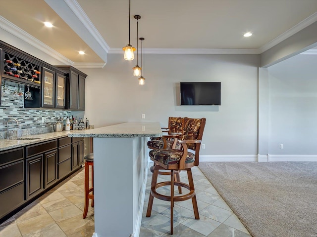 bar featuring indoor wet bar, a sink, tasteful backsplash, crown molding, and pendant lighting