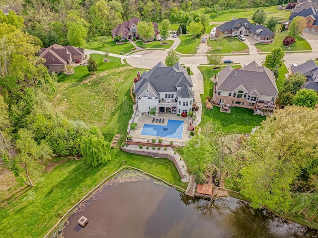 bird's eye view featuring a water view and a residential view