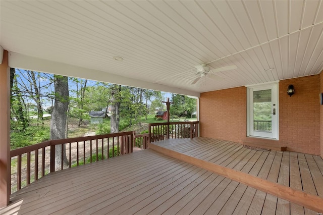 wooden deck with a ceiling fan
