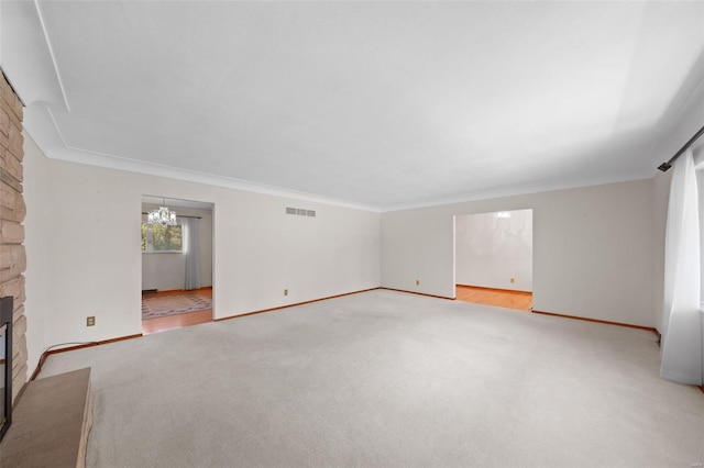 unfurnished living room featuring a fireplace, carpet, visible vents, and baseboards