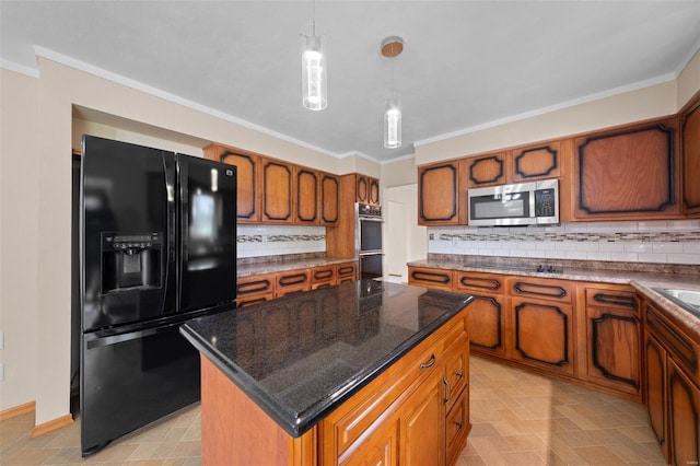 kitchen featuring brown cabinetry, black appliances, backsplash, and decorative light fixtures