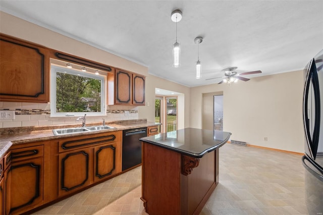 kitchen with freestanding refrigerator, brown cabinetry, backsplash, dishwasher, and a sink