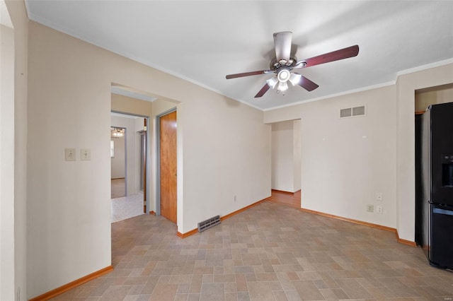 interior space with ornamental molding, ceiling fan, baseboards, and visible vents