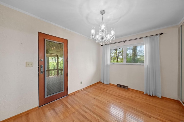 unfurnished dining area with a chandelier, visible vents, ornamental molding, and light wood-style flooring