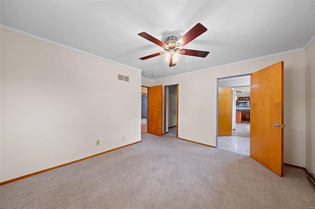 unfurnished bedroom featuring baseboards, visible vents, ornamental molding, and light carpet